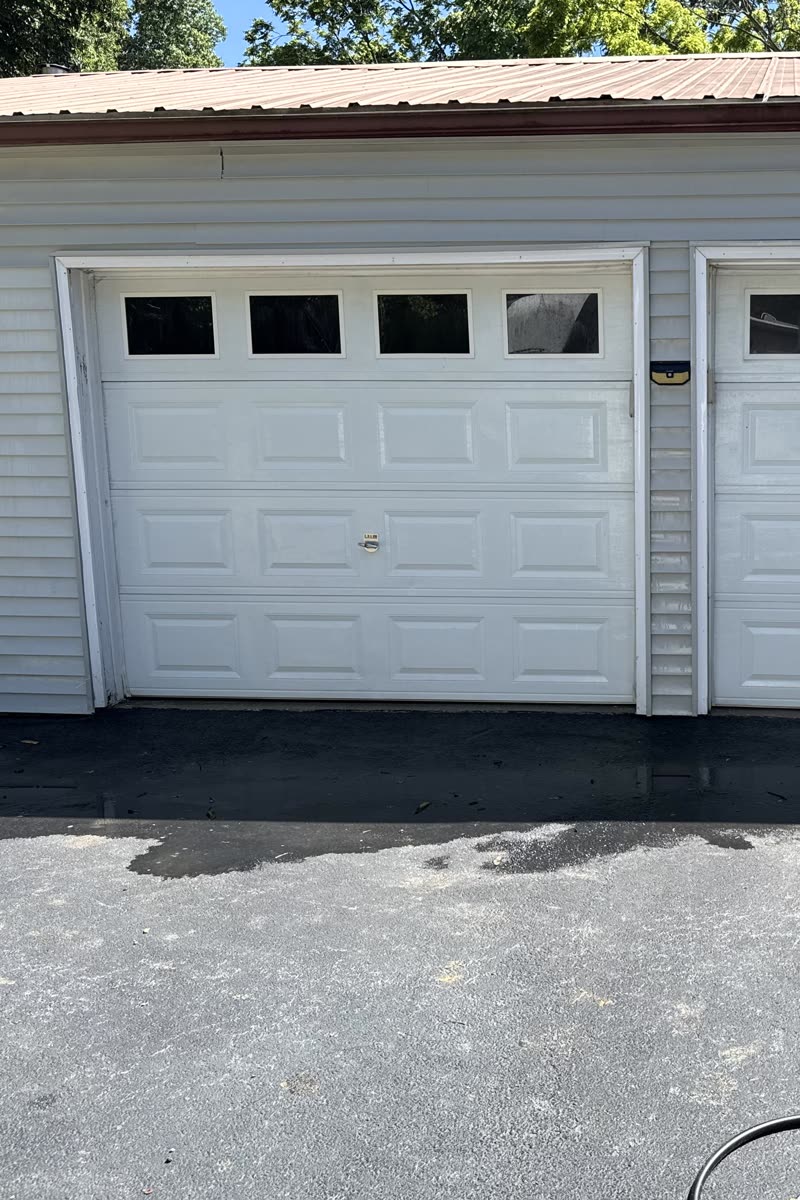 The same garage door after soft washing, white again